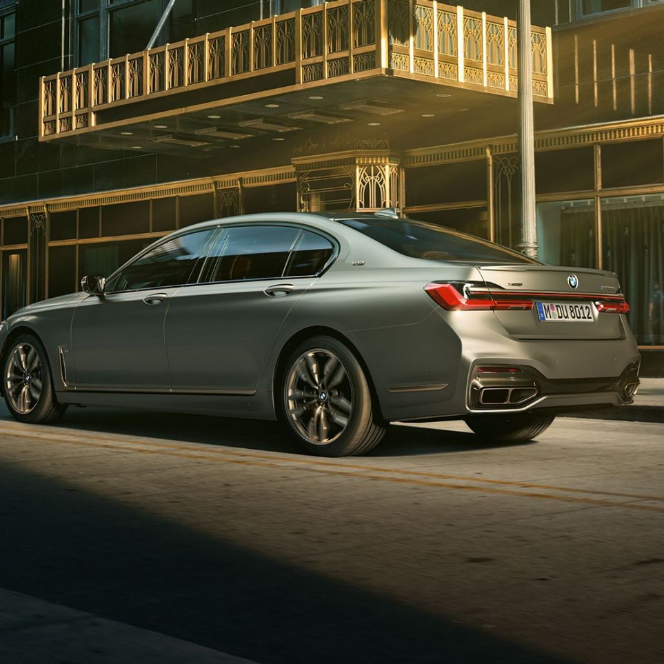 BMW M760Li xDrive with V12 engine BMW M760Li xDrive stands in lateral rear view in front of skyscrapers in urban setting