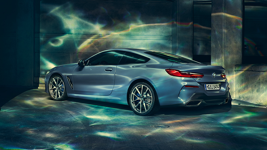 תצלום במבט צד שמאל של BMW סידרה 8 קופה בסביבה עירונית.