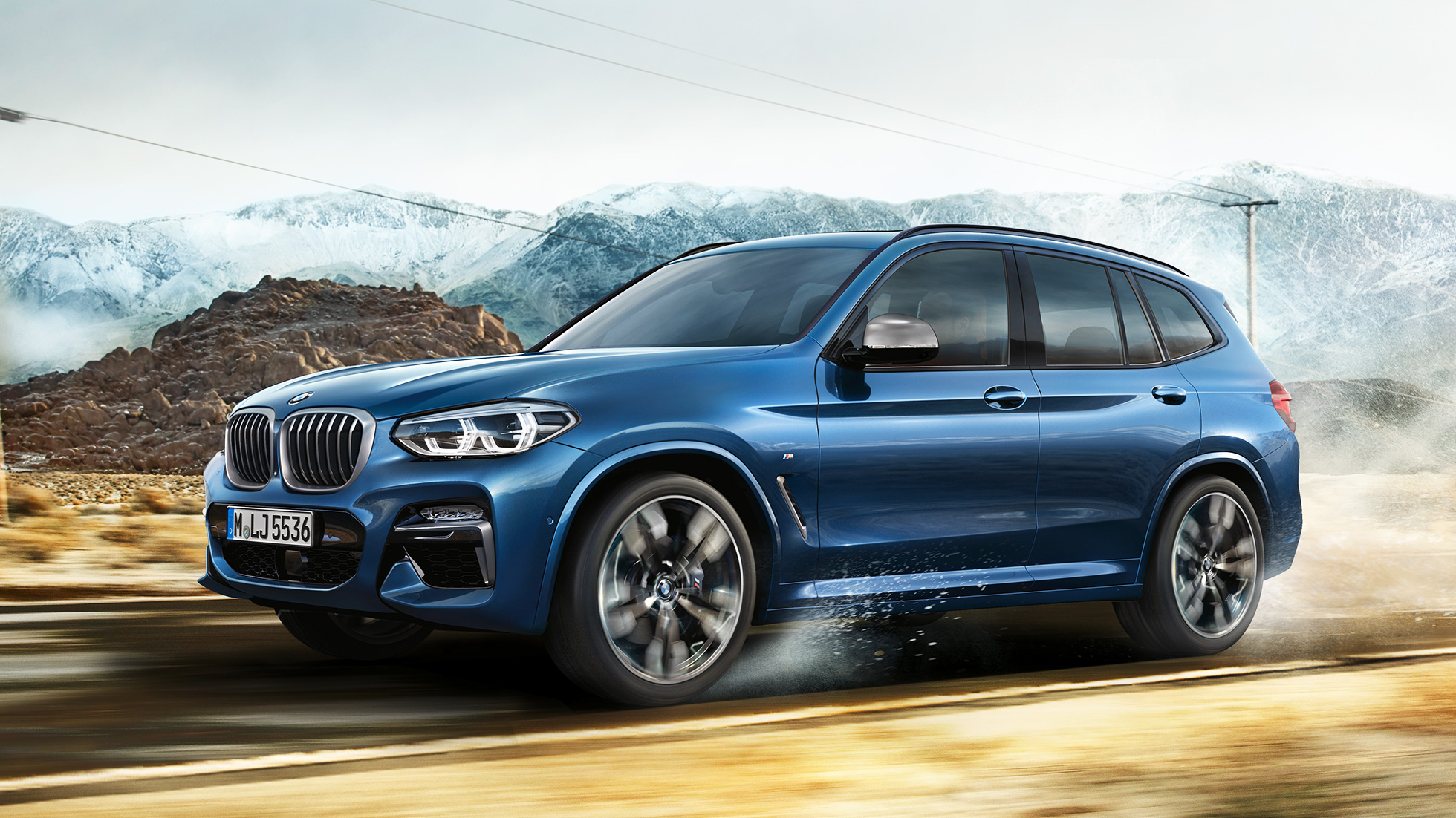 BMW X3 M40i, תמונה של חישוק ופגוש קדמי והרים ברקע BMW X3 M40i, תמונה של חישוק ופגוש קדמי והרים ברקע