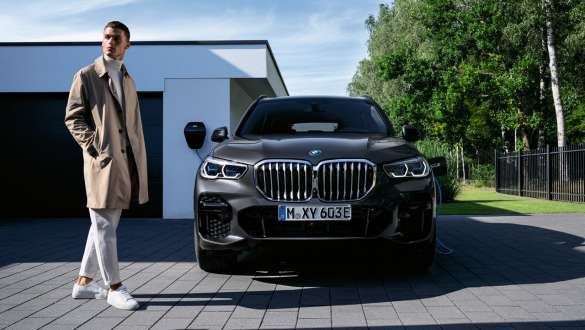 פלאג-אין הייבריד BMW X5 xDrive45e מבט קדמי לפני חניה פלאג-אין הייבריד BMW X5 xDrive45e מבט קדמי לפני חניה עם דוגמנית